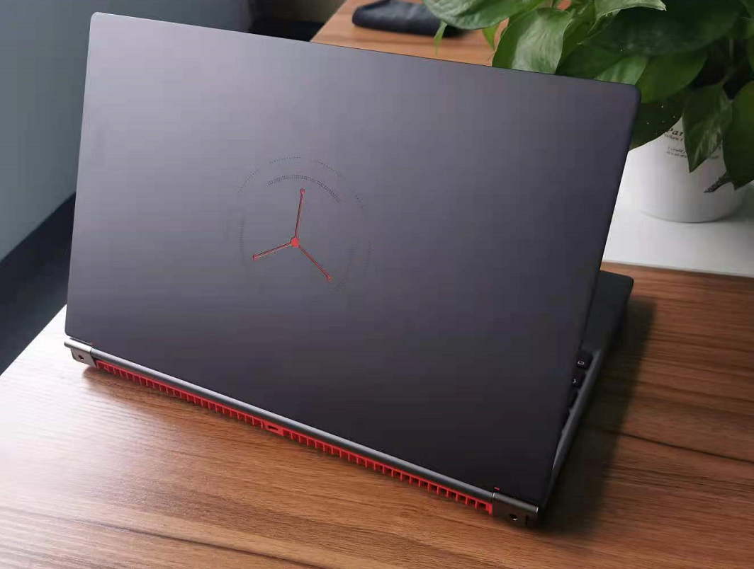 Laptop with a brand logo on a wooden desk